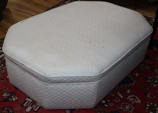 A large octagonal pouffe, upholstered in cream damask L.150cm approx.